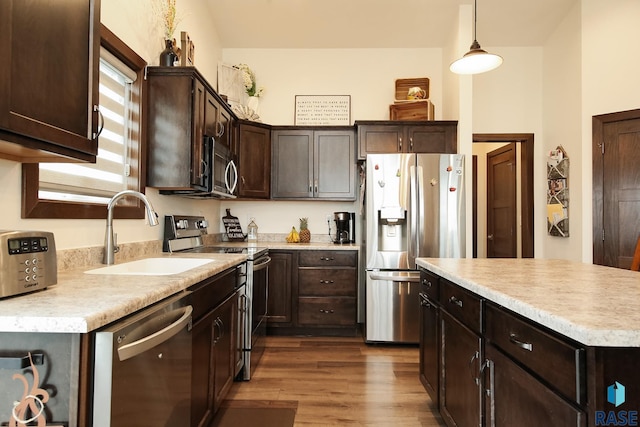 812 Trojan Ave, Hartford, SD 57033 - kitchen with appliances with stainless steel finishes, a sink, dark brown cabinets, and light countertops