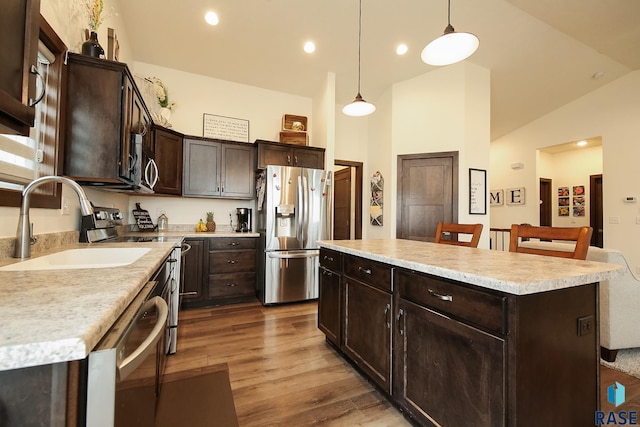 812 Trojan Ave, Hartford, SD 57033 - kitchen with appliances with stainless steel finishes, a sink, dark brown cabinets, dark wood-style floors, and light countertops