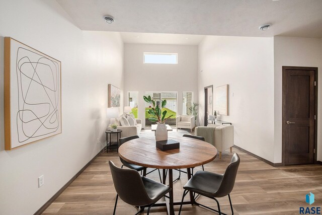dining room featuring baseboards and light wood finished floors