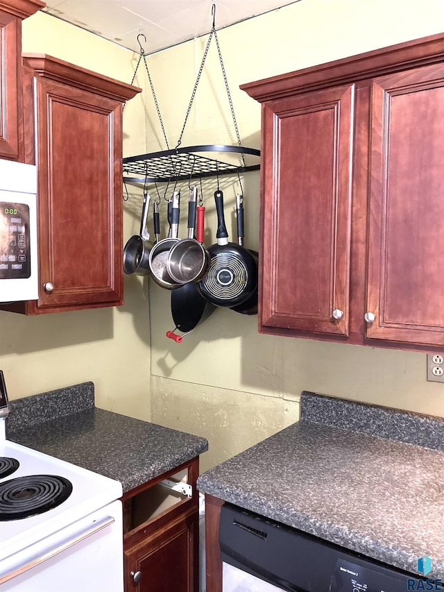 305 S 5th St, Menno, SD 57045 - kitchen featuring dark brown cabinets, white appliances, and dark countertops