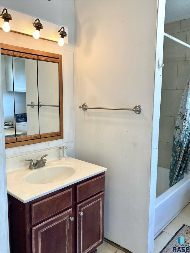 305 S 5th St, Menno, SD 57045 - bathroom featuring vanity, shower / tub combo with curtain, washer / dryer, and tile patterned floors