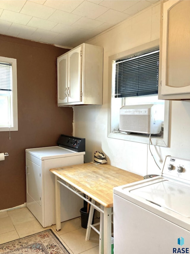 305 S 5th St, Menno, SD 57045 - washroom featuring independent washer and dryer, light tile patterned floors, and cabinet space