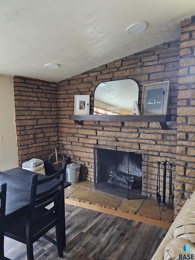1005 8th Ave, Pipestone, MN 56164 - living area with a textured ceiling, wood finished floors, and a fireplace