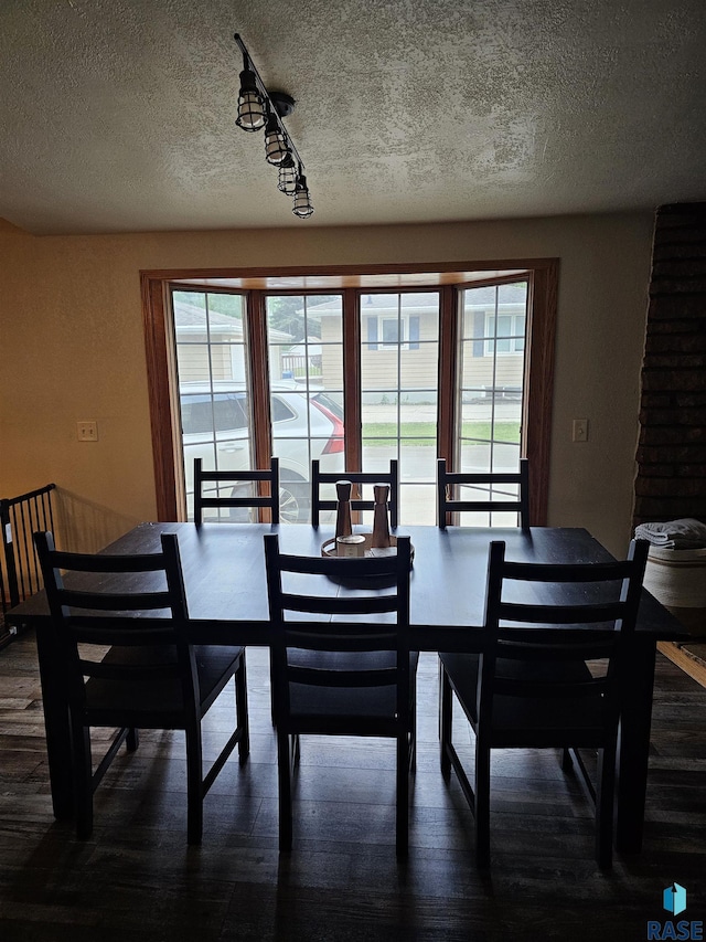 1005 8th Ave, Pipestone, MN 56164 - dining room with dark wood-style flooring, healthy amount of natural light, and a textured ceiling