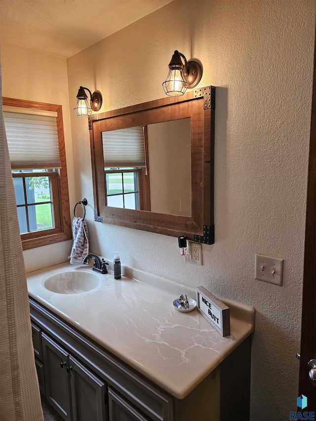 1005 8th Ave, Pipestone, MN 56164 - bathroom with a textured wall and vanity