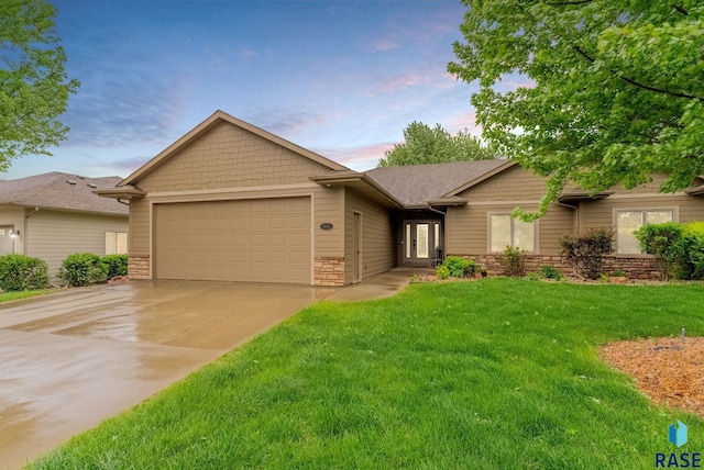 5616 S Shadow Wood Pl, Sioux Falls, SD 57108 - view of front of home with an attached garage, driveway, a yard, and stone siding