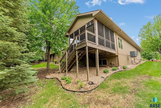 5616 S Shadow Wood Pl, Sioux Falls, SD 57108 - back of house featuring a sunroom, a lawn, and stairs