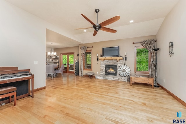 5616 S Shadow Wood Pl, Sioux Falls, SD 57108 - living room with wood finished floors, a chandelier, a ceiling fan, a fireplace, and baseboards