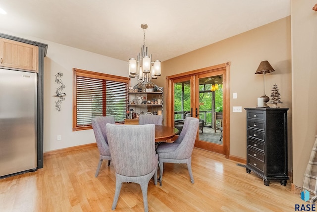 5616 S Shadow Wood Pl, Sioux Falls, SD 57108 - dining room with light wood finished floors, baseboards, and a chandelier