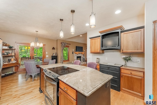 5616 S Shadow Wood Pl, Sioux Falls, SD 57108 - kitchen featuring stainless steel range with electric cooktop, a kitchen island, light wood-type flooring, a chandelier, and decorative light fixtures