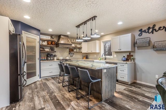 25265 466th Ave, Hartford, SD 57033 - kitchen featuring stainless steel fridge with ice dispenser, custom exhaust hood, open shelves, dark wood finished floors, and a textured ceiling