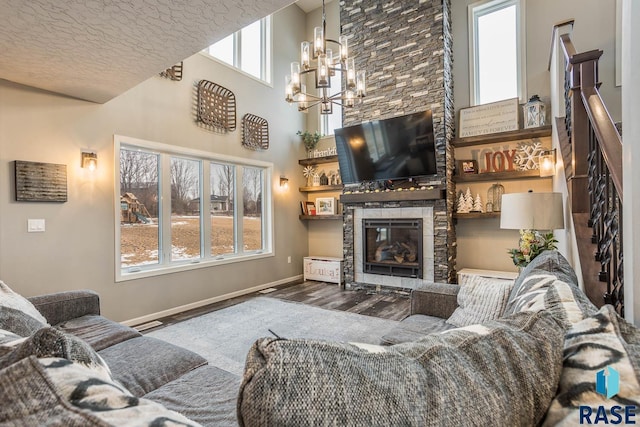 25265 466th Ave, Hartford, SD 57033 - living area with wood finished floors, a fireplace, a chandelier, and baseboards