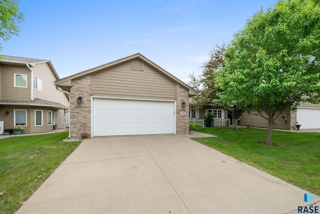 7200 S Hoffman Pl, Sioux Falls, SD 57108 - view of front facade with brick siding, a front lawn, and driveway