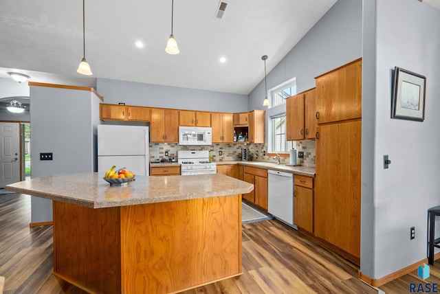 7200 S Hoffman Pl, Sioux Falls, SD 57108 - kitchen featuring white appliances, tasteful backsplash, a sink, dark wood-style floors, and light countertops