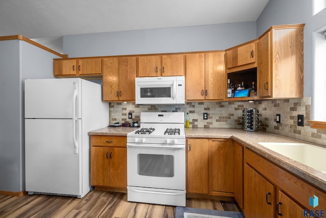 7200 S Hoffman Pl, Sioux Falls, SD 57108 - kitchen with white appliances, wood finished floors, light countertops, and tasteful backsplash