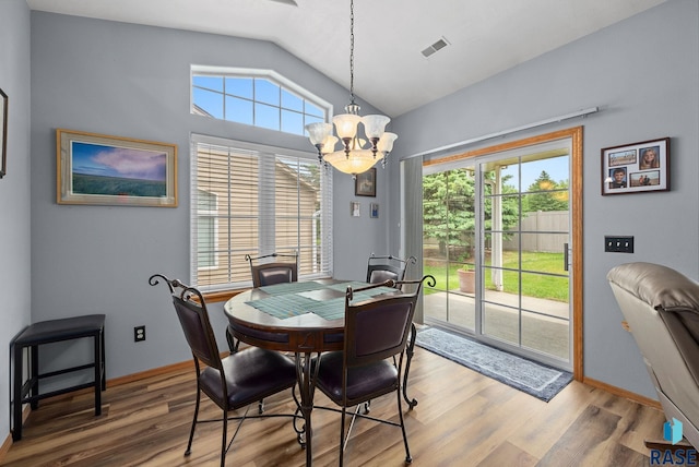 7200 S Hoffman Pl, Sioux Falls, SD 57108 - dining area with lofted ceiling, wood finished floors, a chandelier, healthy amount of natural light, and baseboards