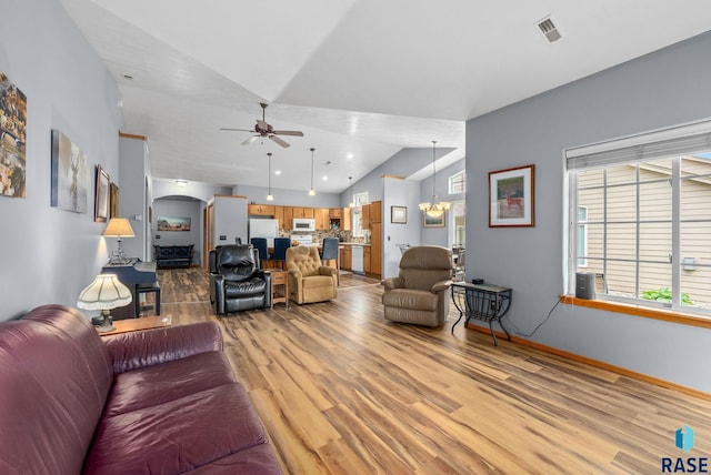 7200 S Hoffman Pl, Sioux Falls, SD 57108 - living area featuring light wood finished floors, a ceiling fan, plenty of natural light, a chandelier, and high vaulted ceiling