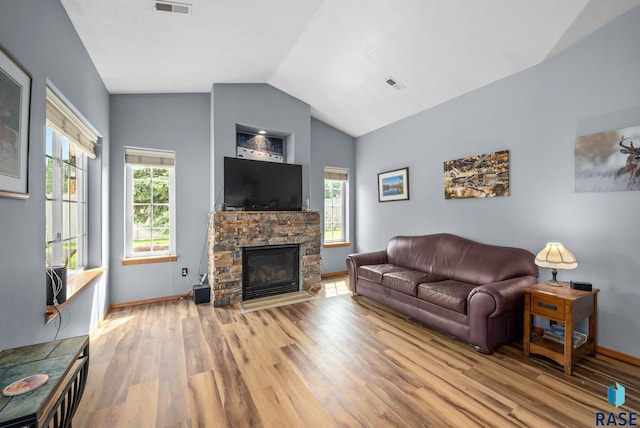 7200 S Hoffman Pl, Sioux Falls, SD 57108 - living room with wood finished floors, vaulted ceiling, baseboards, and a fireplace