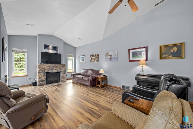 7200 S Hoffman Pl, Sioux Falls, SD 57108 - living room featuring vaulted ceiling, wood finished floors, ceiling fan, a fireplace, and baseboards