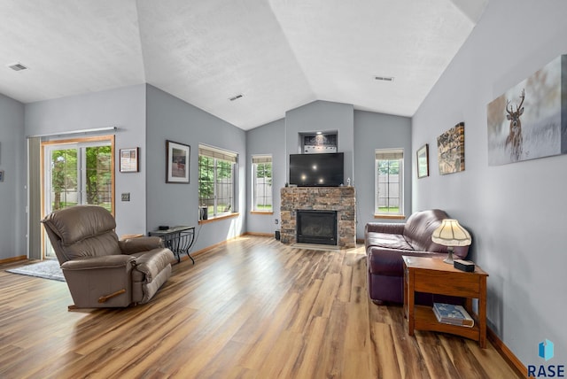 7200 S Hoffman Pl, Sioux Falls, SD 57108 - living area featuring wood finished floors, vaulted ceiling, a fireplace, and baseboards