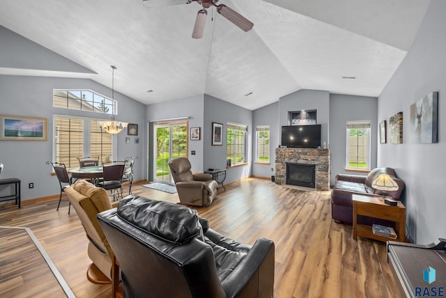 7200 S Hoffman Pl, Sioux Falls, SD 57108 - living area featuring lofted ceiling, a chandelier, wood finished floors, a fireplace, and a ceiling fan