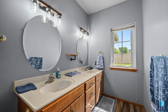 7200 S Hoffman Pl, Sioux Falls, SD 57108 - bathroom with double vanity, wood finished floors, and baseboards