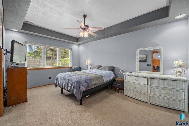 7200 S Hoffman Pl, Sioux Falls, SD 57108 - bedroom featuring a tray ceiling, carpet floors, baseboards, and ceiling fan