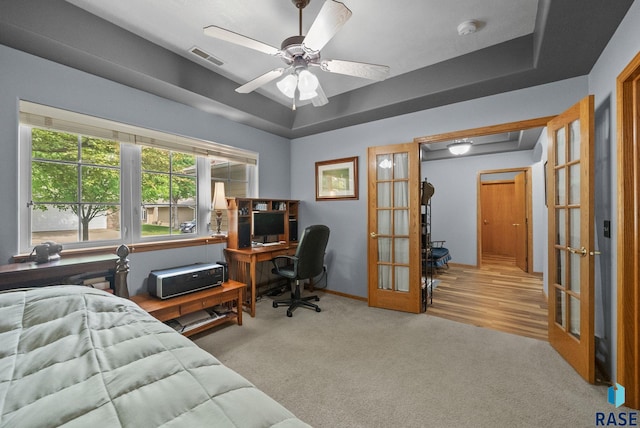 7200 S Hoffman Pl, Sioux Falls, SD 57108 - carpeted bedroom featuring an office area, french doors, baseboards, a tray ceiling, and a ceiling fan