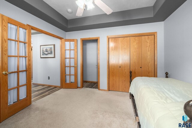 7200 S Hoffman Pl, Sioux Falls, SD 57108 - carpeted bedroom with baseboards, french doors, a ceiling fan, and two closets