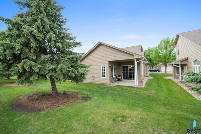7200 S Hoffman Pl, Sioux Falls, SD 57108 - back of house featuring a patio and a lawn