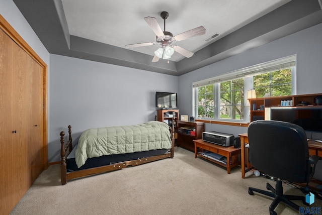 7200 S Hoffman Pl, Sioux Falls, SD 57108 - carpeted bedroom with an office area, a ceiling fan, a tray ceiling, and a closet