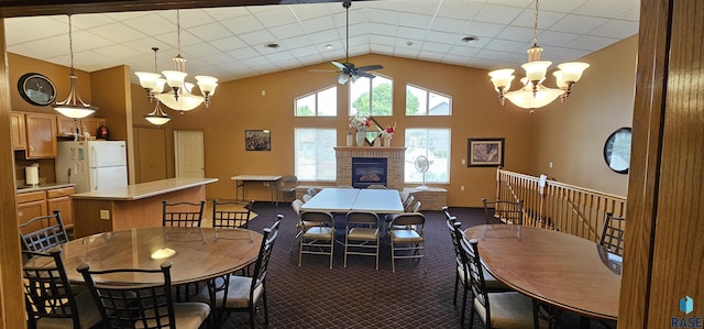 7200 S Hoffman Pl, Sioux Falls, SD 57108 - dining area with a chandelier, a ceiling fan, a glass covered fireplace, carpet floors, and high vaulted ceiling