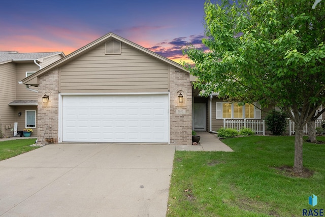 7200 S Hoffman Pl, Sioux Falls, SD 57108 - view of front facade featuring brick siding, driveway, an attached garage, and a front yard