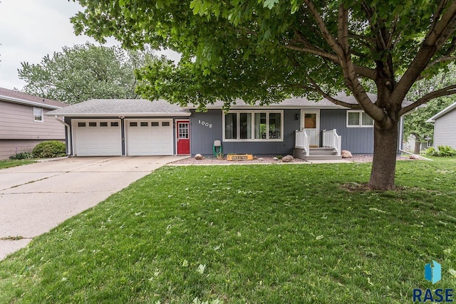 1002 N Carol St, Luverne, MN 56156 - ranch-style house featuring an attached garage, concrete driveway, and a front lawn