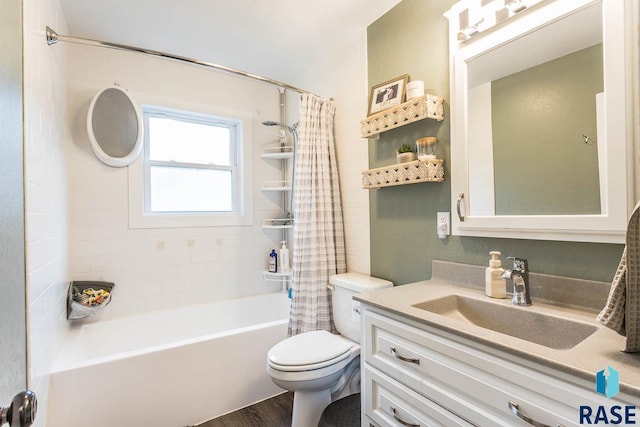 1002 N Carol St, Luverne, MN 56156 - bathroom with toilet, wood finished floors, shower / tub combo, and vanity