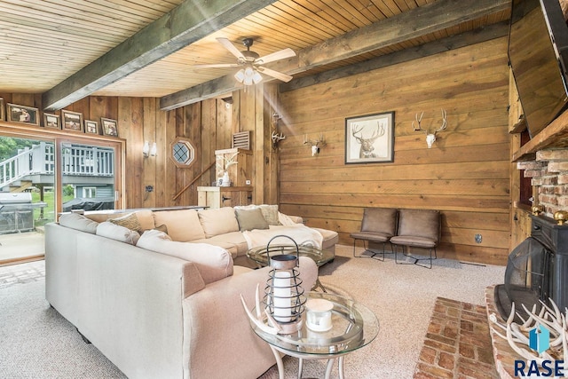 1002 N Carol St, Luverne, MN 56156 - living room with beamed ceiling, wooden walls, wooden ceiling, ceiling fan, and carpet floors