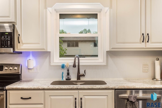 1002 N Carol St, Luverne, MN 56156 - kitchen with a sink, appliances with stainless steel finishes, and white cabinets