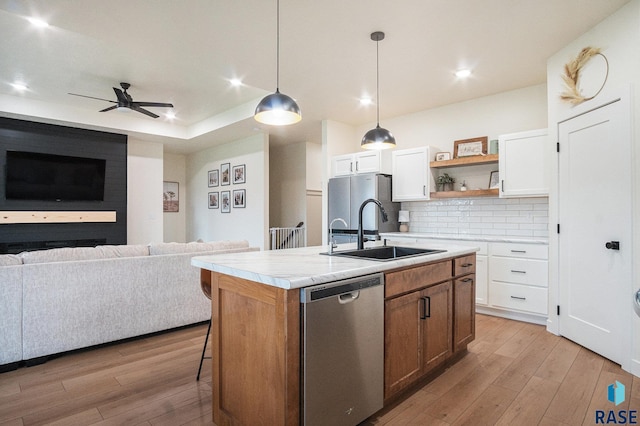 110 Skyline Dr, Valley Springs, SD 57068 - kitchen featuring stainless steel appliances, a sink, open floor plan, light wood-type flooring, and recessed lighting
