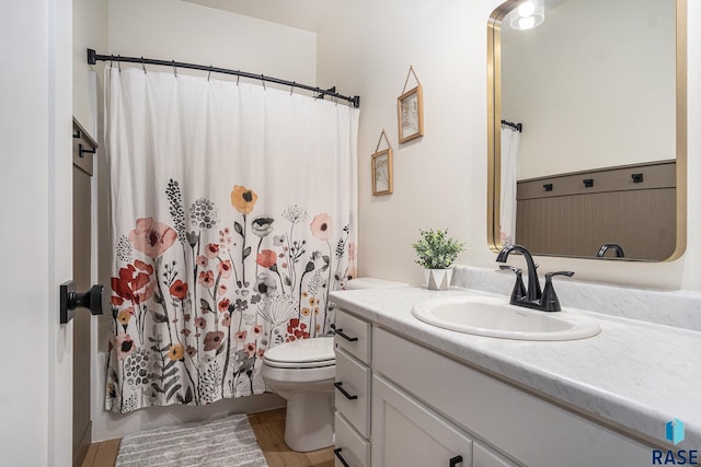 110 Skyline Dr, Valley Springs, SD 57068 - bathroom with toilet, vanity, wood finished floors, and shower / bath combination with curtain