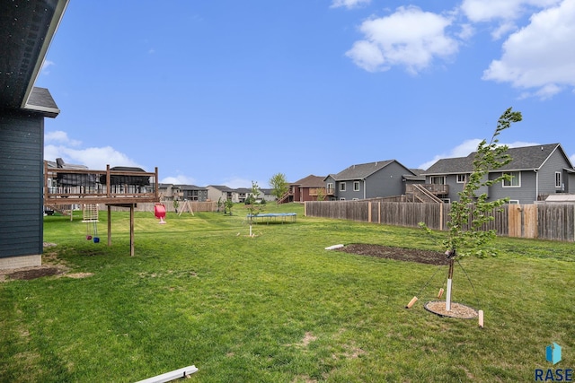 110 Skyline Dr, Valley Springs, SD 57068 - view of yard featuring a trampoline, a residential view, and a deck