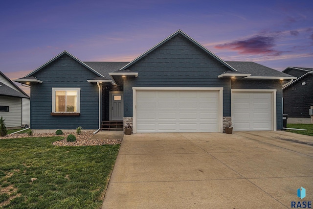 110 Skyline Dr, Valley Springs, SD 57068 - view of front of property featuring concrete driveway, an attached garage, a front lawn, and stone siding