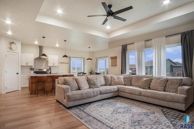 110 Skyline Dr, Valley Springs, SD 57068 - living room featuring a tray ceiling, recessed lighting, light wood finished floors, and a ceiling fan