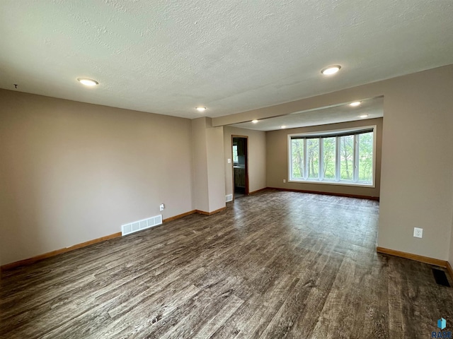 210 160th Ave, Edgerton, MN 56156 - empty room featuring dark wood-type flooring, baseboards, a textured ceiling, and recessed lighting