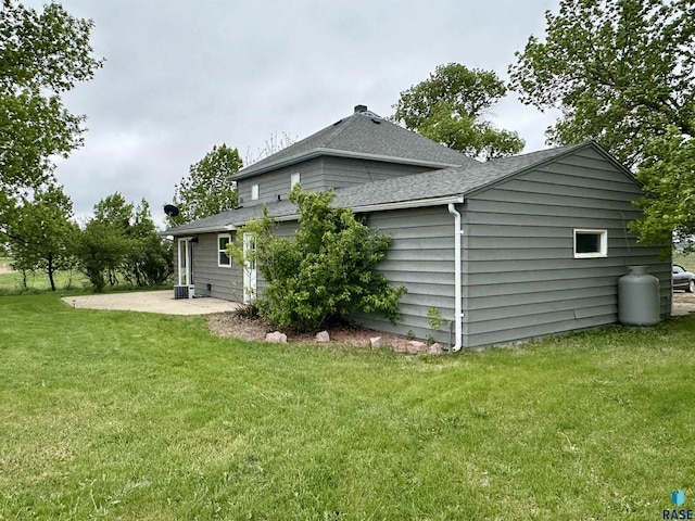 210 160th Ave, Edgerton, MN 56156 - back of house featuring a patio, a shingled roof, and a yard