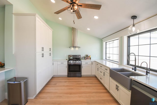 47138 293rd St, Beresford, SD 57004 - kitchen with appliances with stainless steel finishes, a sink, wall chimney exhaust hood, healthy amount of natural light, and recessed lighting