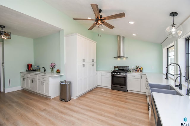 47138 293rd St, Beresford, SD 57004 - kitchen with stainless steel appliances, wall chimney range hood, a sink, white cabinets, and recessed lighting