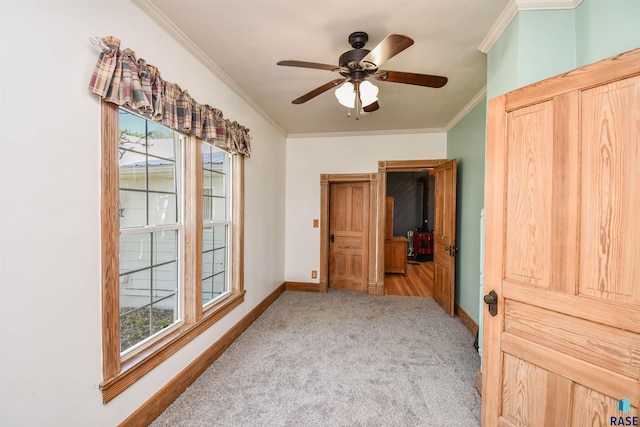 47138 293rd St, Beresford, SD 57004 - empty room featuring crown molding, carpet flooring, baseboards, and a ceiling fan