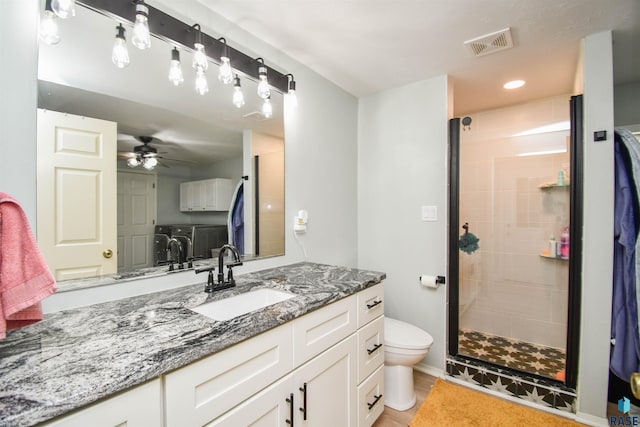 47138 293rd St, Beresford, SD 57004 - full bathroom featuring independent washer and dryer, a shower stall, toilet, vanity, and ceiling fan