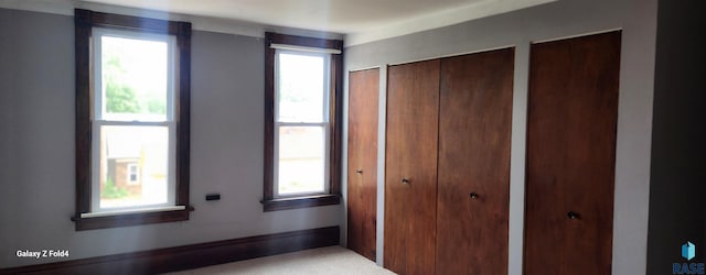 120 Main St, Scotland, SD 57059 - unfurnished bedroom featuring multiple closets and multiple windows