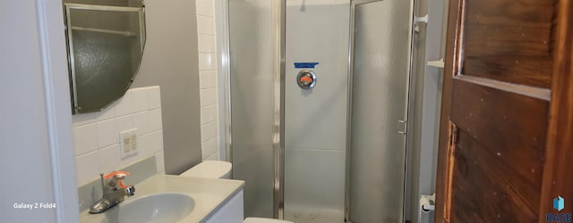 120 Main St, Scotland, SD 57059 - full bathroom featuring a shower stall, toilet, vanity, and tile walls